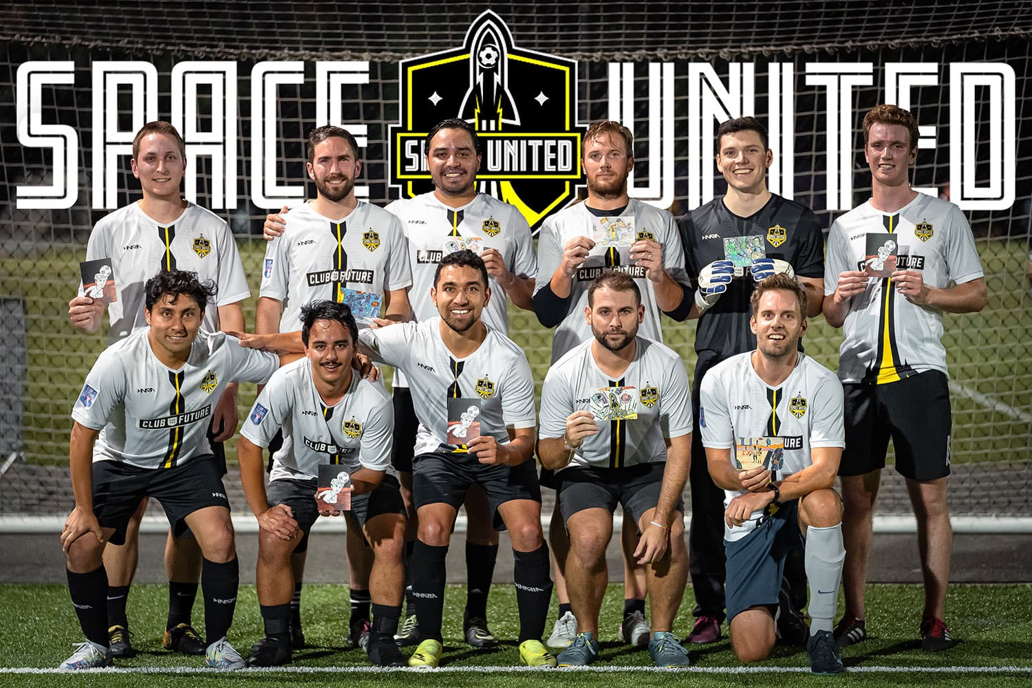 A team wearing white soccer jerseys holds up postcards with drawings